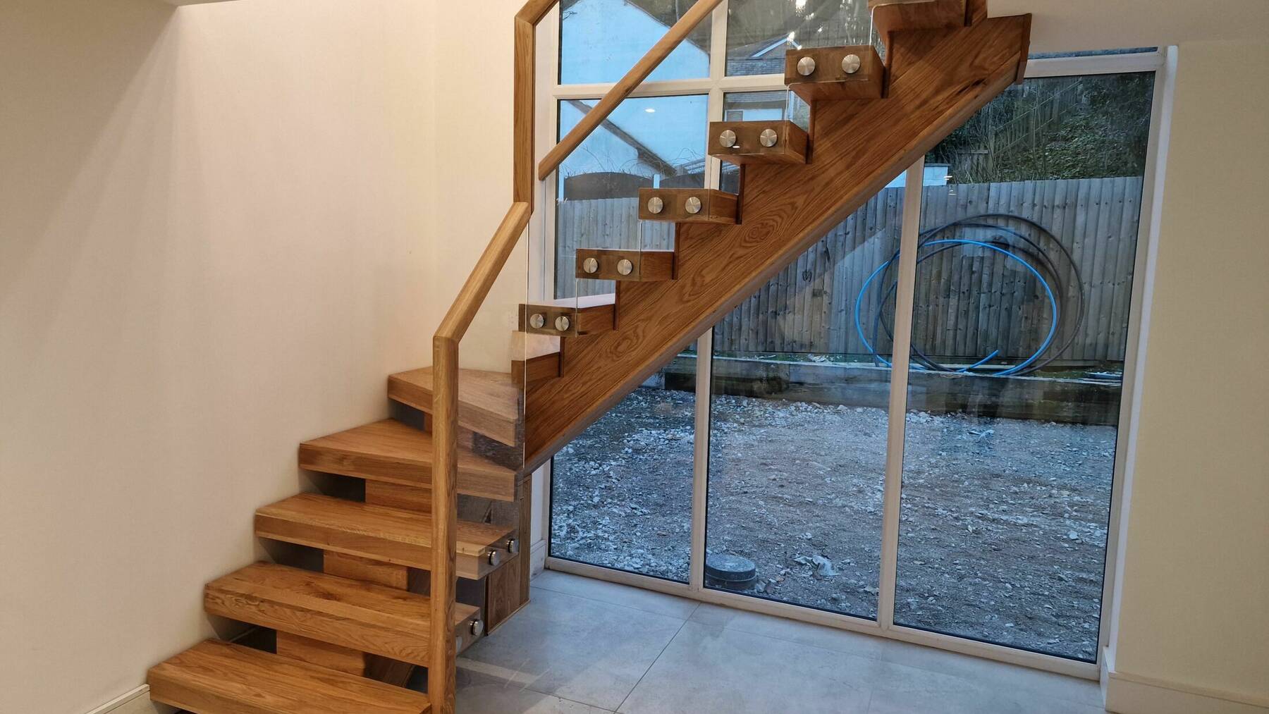 Solid Oak Central String Staircase with Oak Handrail & Glass Panels